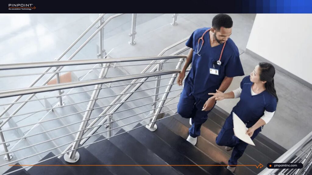 Nurses discussing healthcare safety and privacy in a hospital stairwell