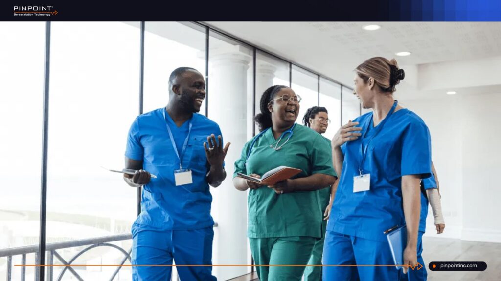 Healthcare team discussing patient safety and panic button alarm systems in a hospital