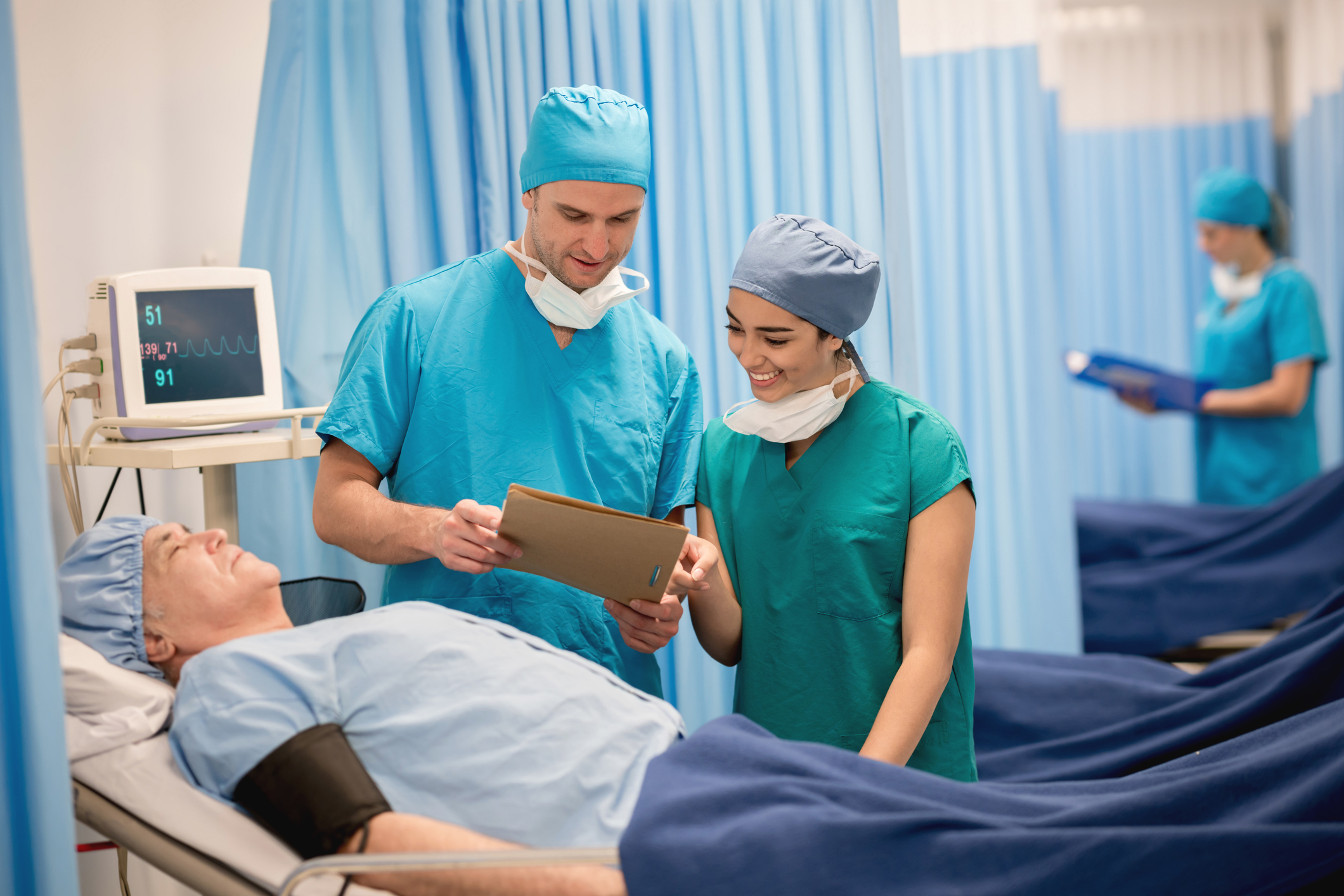 Doctors checking on a patient at the ER