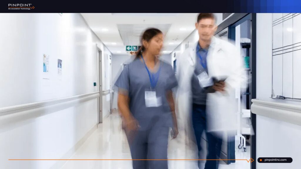 Healthcare staff walking through hospital corridor during a delayed panic alarm response
