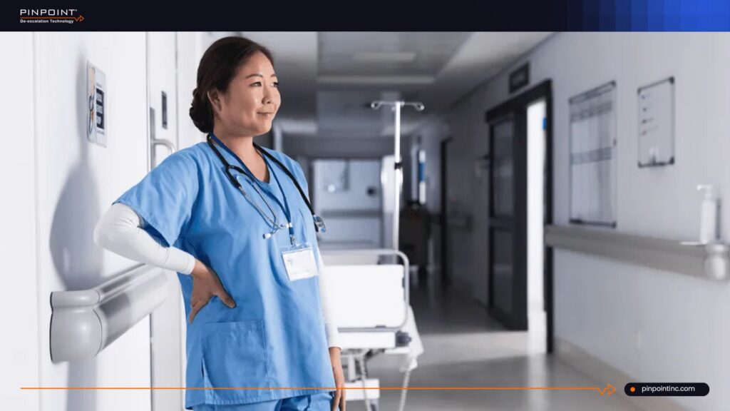 Nurse standing in hospital hallway showing the importance of panic buttons for healthcare workers