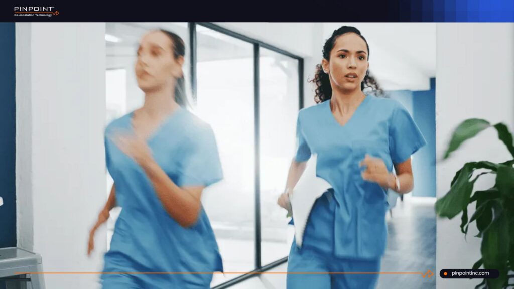 Nurses running through hospital corridor during emergency response without staff tracking