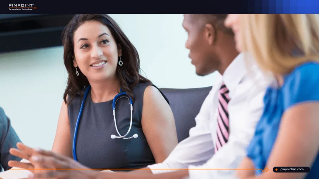 Healthcare staff meeting about a non-tracking nurse safety system for hospital workplace safety