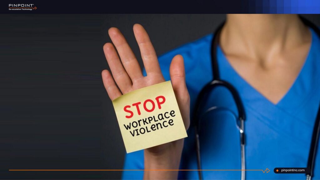Pinpoint guide on workplace violence in healthcare showing a healthcare worker holding a stop workplace violence message to represent staff safety, prevention, and nurse protection.