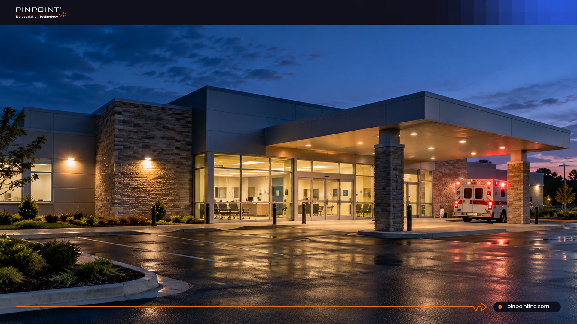 Pinpoint guide on panic buttons for freestanding emergency departments without on-site IT, showing a standalone emergency room building at dusk with an ambulance parked under the entrance canopy.